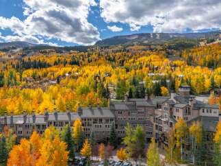Experience the beauty of mountain living in this stunning property, surrounded by vibrant fall foliage.