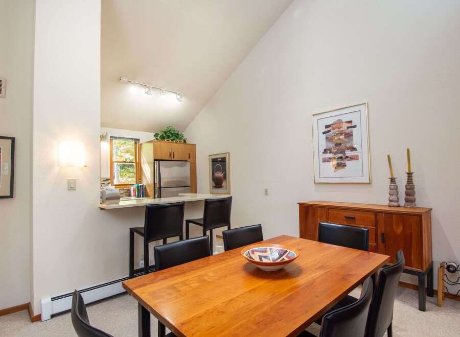 This stunning dining area features a beautiful wooden table, perfect for hosting gatherings.