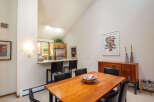 This stunning dining area features a beautiful wooden table, perfect for hosting gatherings.