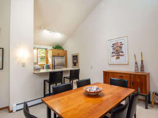 This stunning dining area features a beautiful wooden table, perfect for hosting gatherings.