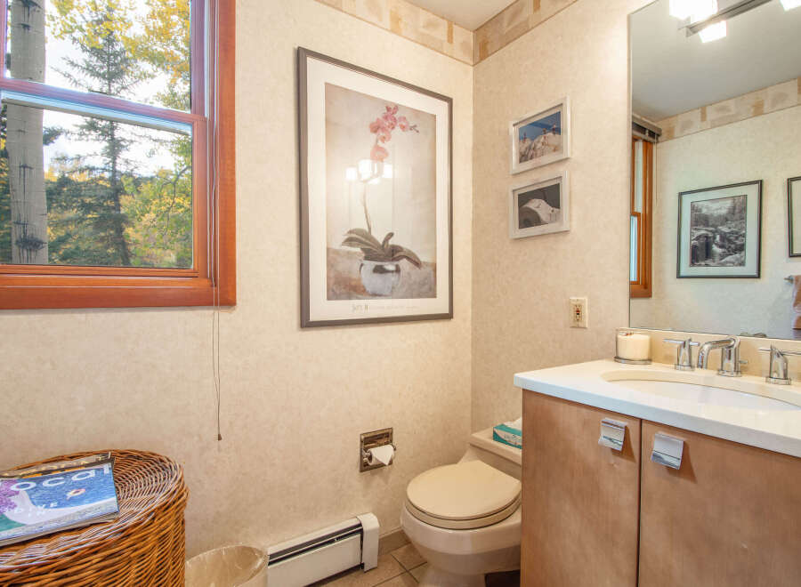This inviting bathroom features a serene ambiance with its neutral color palette and natural light.