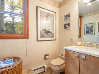 This inviting bathroom features a serene ambiance with its neutral color palette and natural light.
