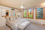 This beautiful bedroom offers a serene retreat with its neutral color palette and ample natural light.