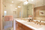 Step into luxury with this stunning bathroom featuring a sleek glass shower enclosure and a double vanity.