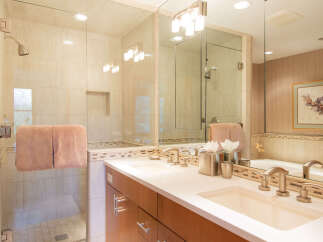 Step into luxury with this stunning bathroom featuring a sleek glass shower enclosure and a double vanity.