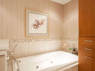 This luxurious bathroom features a modern soaking tub, perfect for relaxation.