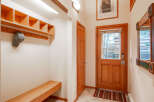 Step into this inviting entry with a custom-built bench and storage, perfect for keeping your space organized.