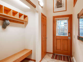 Step into this inviting entry with a custom-built bench and storage, perfect for keeping your space organized.