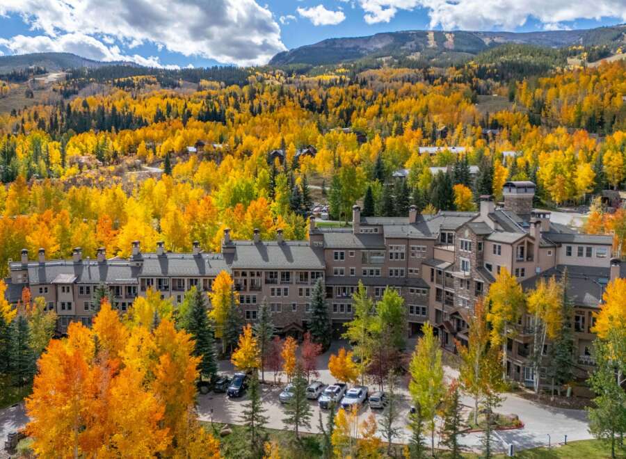 Experience the beauty of mountain living in this stunning property surrounded by vibrant fall foliage.