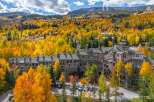 Experience the beauty of mountain living in this stunning property surrounded by vibrant fall foliage.