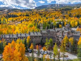 Experience the beauty of mountain living in this stunning property surrounded by vibrant fall foliage.