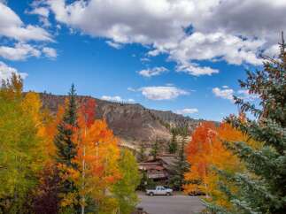 Discover the beauty of mountain living with this stunning property surrounded by vibrant fall foliage.