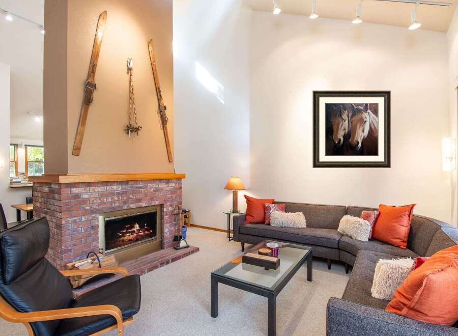This stunning property boasts a cozy living room with a brick fireplace, perfect for those chilly evenings.