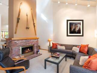 This stunning property boasts a cozy living room with a brick fireplace, perfect for those chilly evenings.
