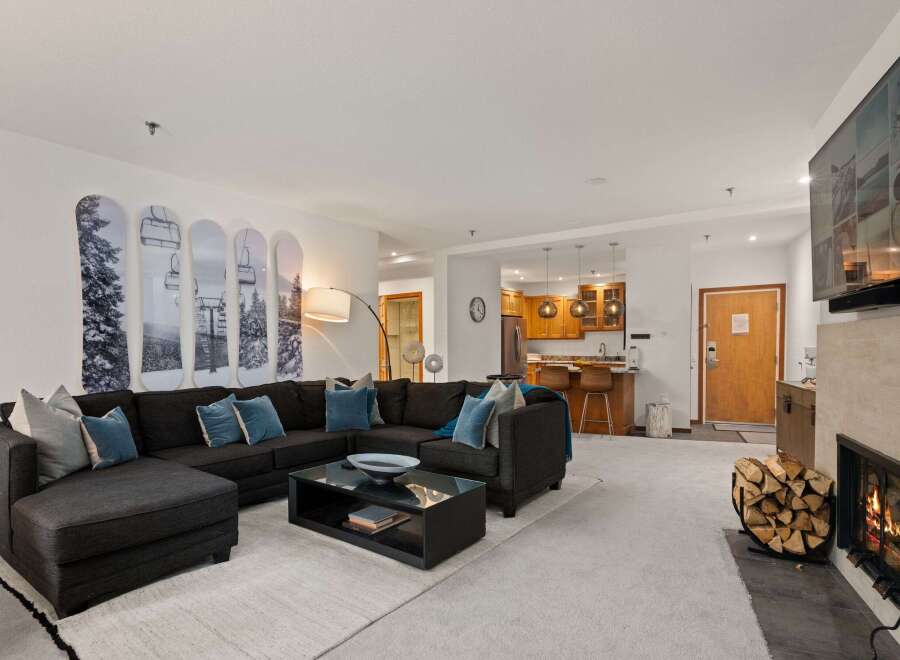 This stunning living space boasts a cozy fireplace, perfect for chilly evenings.