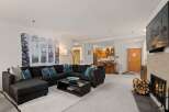 This stunning living space boasts a cozy fireplace, perfect for chilly evenings.