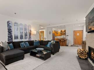 This stunning living space boasts a cozy fireplace, perfect for chilly evenings.