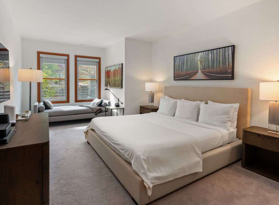 Experience luxury in this stunning bedroom featuring a plush king-sized bed, perfect for a restful night's sleep.