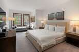 Experience luxury in this stunning bedroom featuring a plush king-sized bed, perfect for a restful night's sleep.