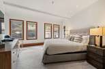 This stunning bedroom boasts a modern design with a neutral color palette, creating a serene and inviting atmosphere.