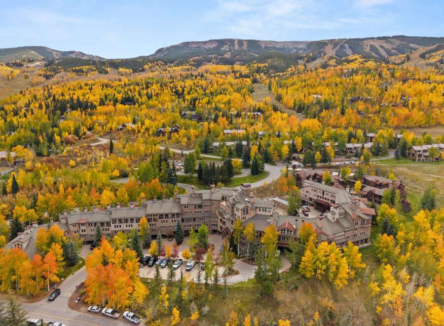 Discover the epitome of mountain living in this stunning property, nestled amidst a vibrant tapestry of fall foliage.