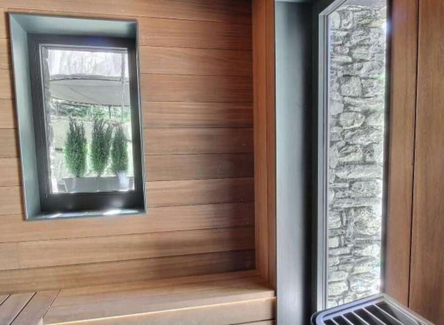 Step into a world of tranquility with this stunning sauna, featuring exquisite wood paneling and a serene ambiance.
