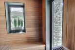 Step into a world of tranquility with this stunning sauna, featuring exquisite wood paneling and a serene ambiance.