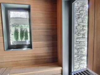 Step into a world of tranquility with this stunning sauna, featuring exquisite wood paneling and a serene ambiance.