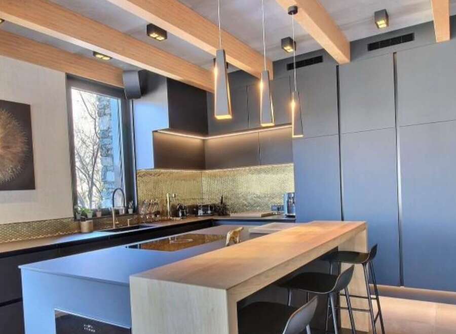 Experience modern luxury in this stunning kitchen! Featuring sleek cabinetry, a stylish breakfast bar, and elegant pendant lighting, this space is perfect for both cooking and entertaining.