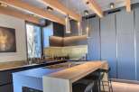 Experience modern luxury in this stunning kitchen! Featuring sleek cabinetry, a stylish breakfast bar, and elegant pendant lighting, this space is perfect for both cooking and entertaining.