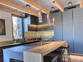 Experience modern luxury in this stunning kitchen! Featuring sleek cabinetry, a stylish breakfast bar, and elegant pendant lighting, this space is perfect for both cooking and entertaining.