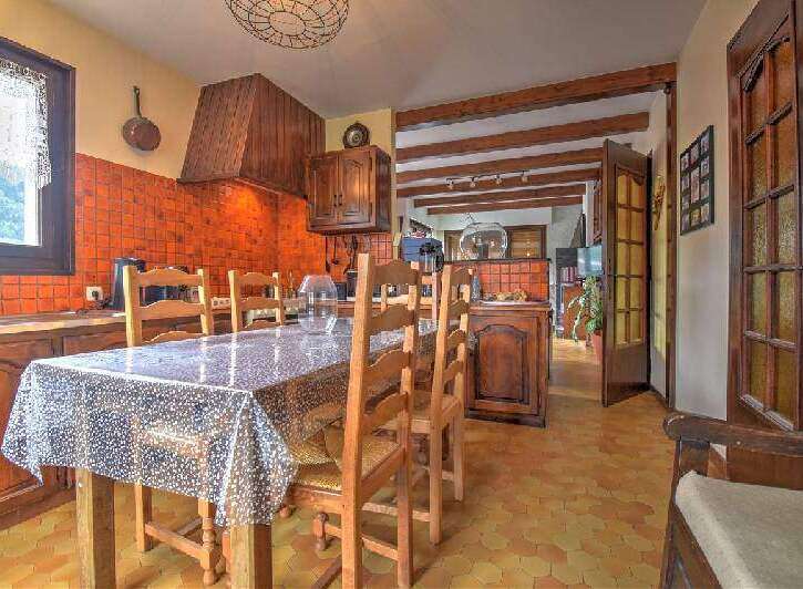 Step into this charming kitchen, featuring rustic wooden cabinets and a cozy dining area.