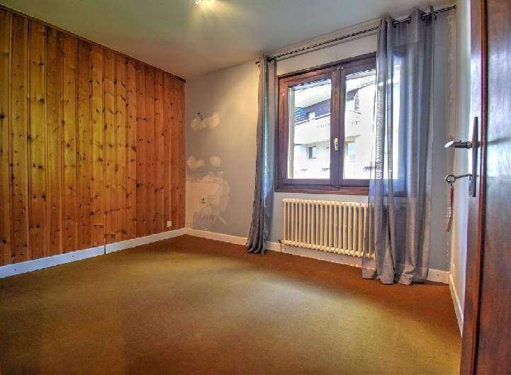 Discover this charming property featuring a cozy interior with a wooden accent wall.