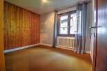 Discover this charming property featuring a cozy interior with a wooden accent wall.