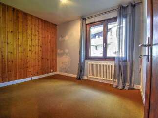 Discover this charming property featuring a cozy interior with a wooden accent wall.