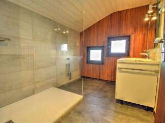 Step into this stunning bathroom featuring a modern walk-in shower with glass enclosure.
