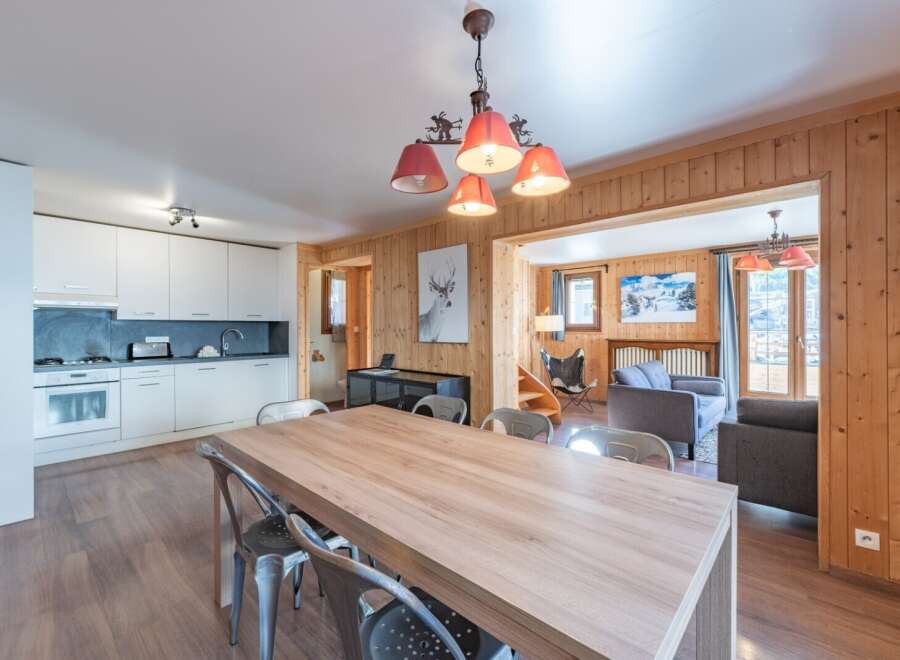 Step into this charming property featuring a spacious dining area with a large wooden table, perfect for gatherings.