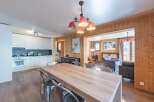 Step into this charming property featuring a spacious dining area with a large wooden table, perfect for gatherings.