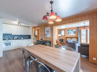 Step into this charming property featuring a spacious dining area with a large wooden table, perfect for gatherings.