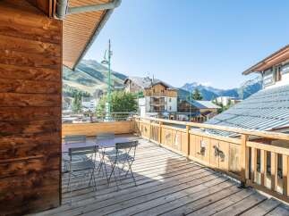 Enjoy breathtaking mountain views from this charming balcony.