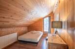 This cozy bedroom features a warm wooden interior, creating a rustic and inviting atmosphere.