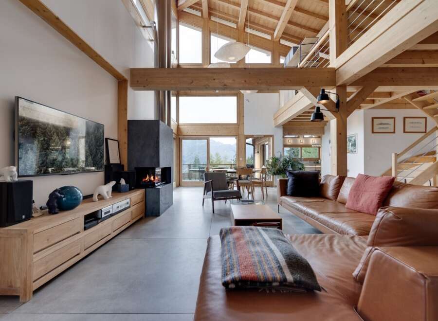 Experience luxury living in this stunning property featuring a spacious living room with a cozy fireplace and a modern entertainment center.