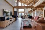 Experience luxury living in this stunning property featuring a spacious living room with a cozy fireplace and a modern entertainment center.