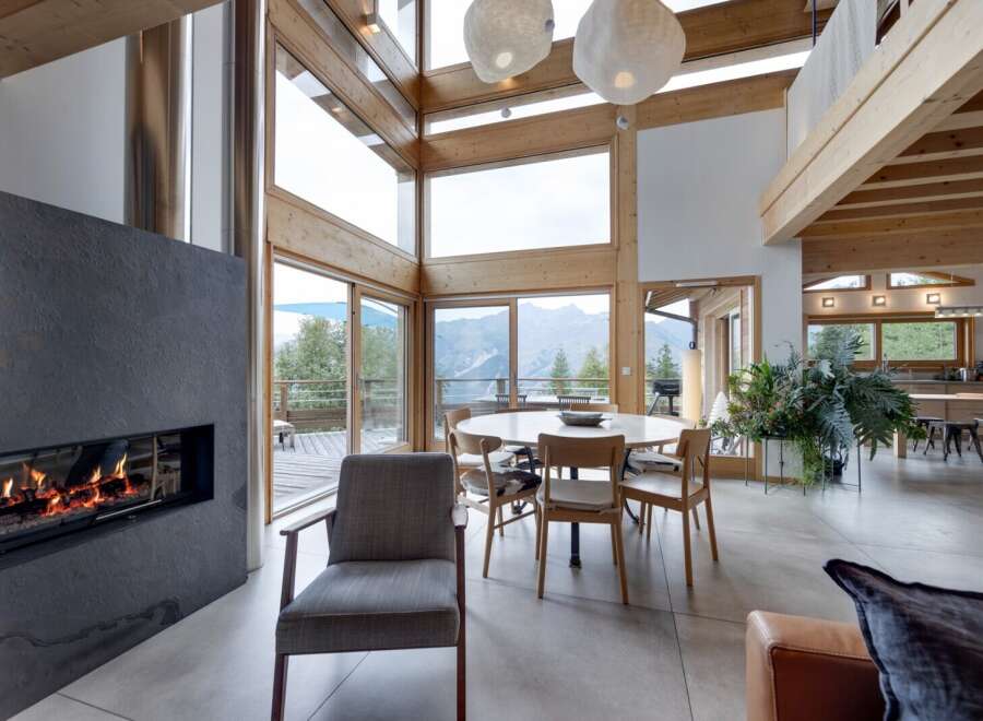 Experience luxury living in this stunning property featuring a modern fireplace, expansive windows, and a bright, open floor plan.