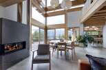 Experience luxury living in this stunning property featuring a modern fireplace, expansive windows, and a bright, open floor plan.