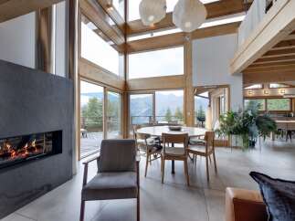 Experience luxury living in this stunning property featuring a modern fireplace, expansive windows, and a bright, open floor plan.
