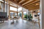 This stunning property boasts a modern open-plan living space with a cozy fireplace and expansive windows that flood the interior with natural light.