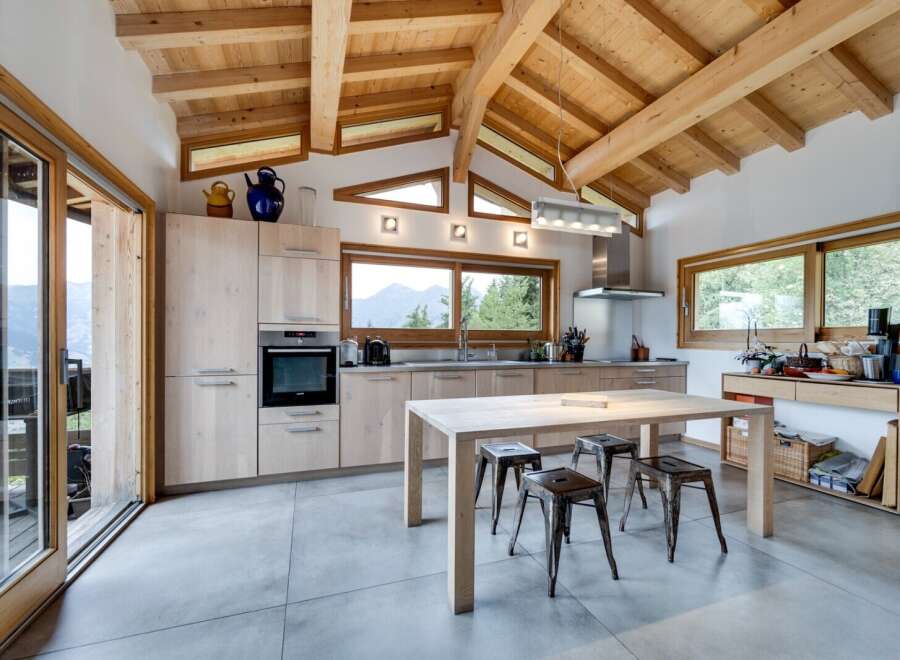 Experience the epitome of modern living in this stunning kitchen, featuring a seamless blend of natural wood elements and contemporary design.