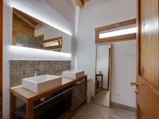 This stunning bathroom features a modern design with a touch of rustic charm.