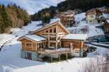 Discover the epitome of mountain living in this stunning chalet nestled amidst a snowy landscape.